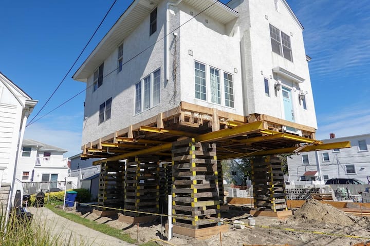 A team of professionals using specialized equipment to raise a house in Keller, preparing it for elevation and renovation